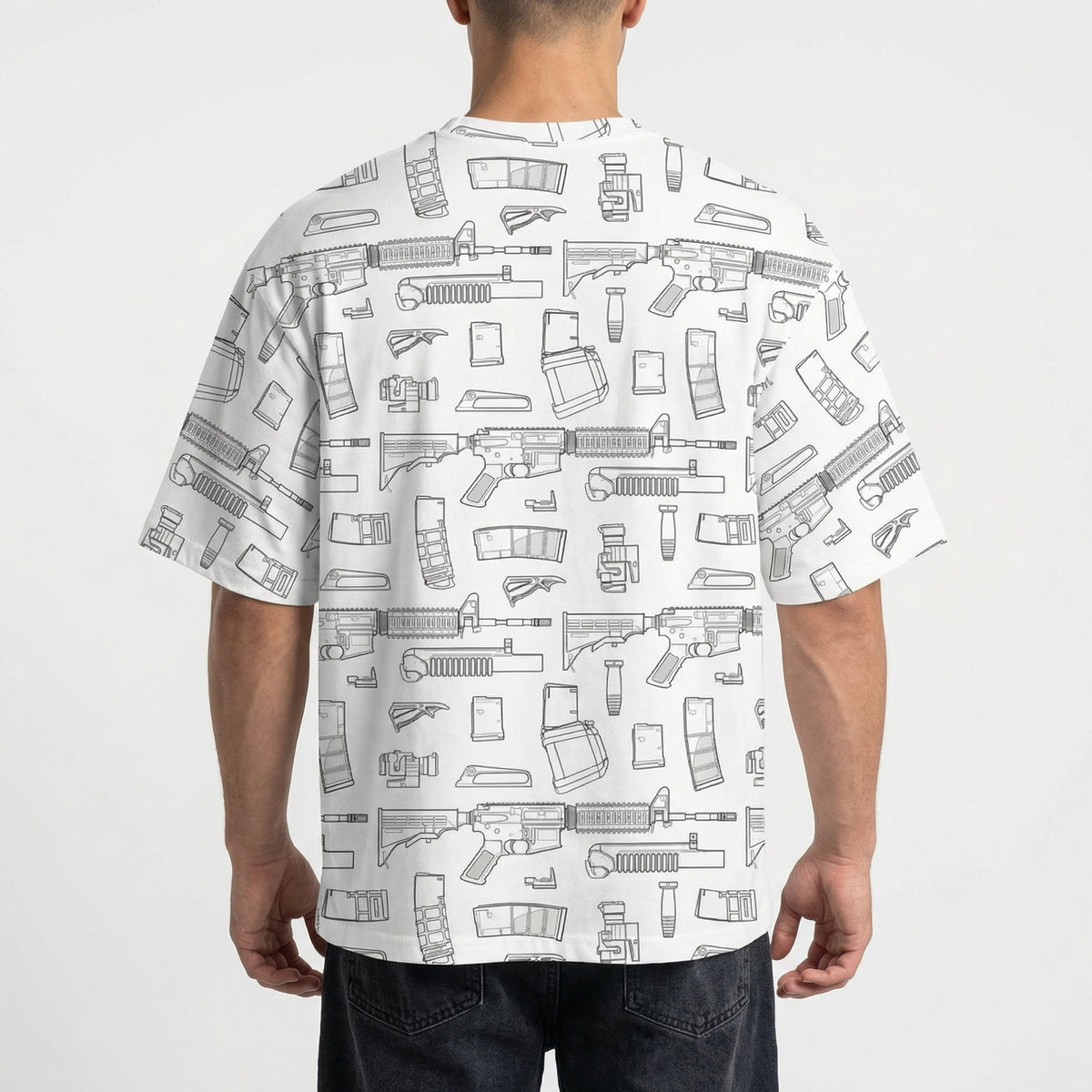 Person wearing a white t-shirt with black line art patterns on a plain background