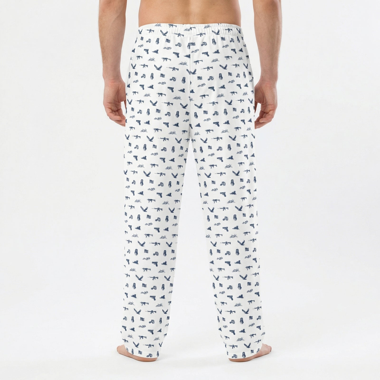 Person wearing white pajama pants with black abstract pattern on a white background