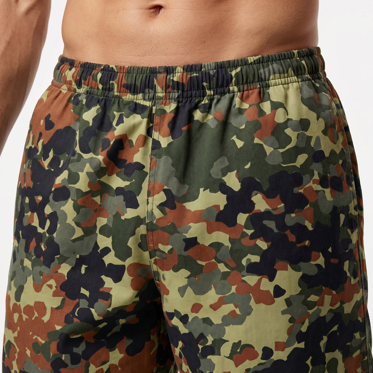 Camouflage shorts worn by a person on a plain background