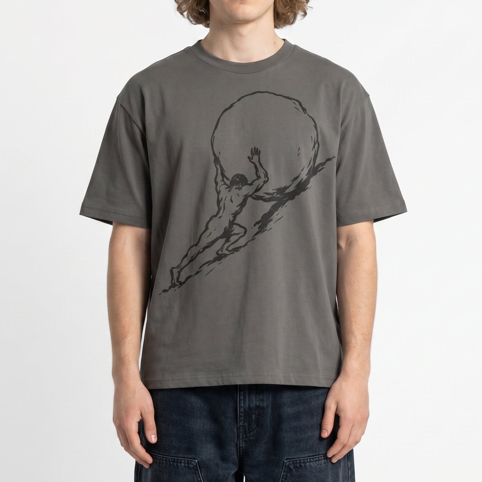 Person wearing a gray t-shirt with a graphic design on a white background