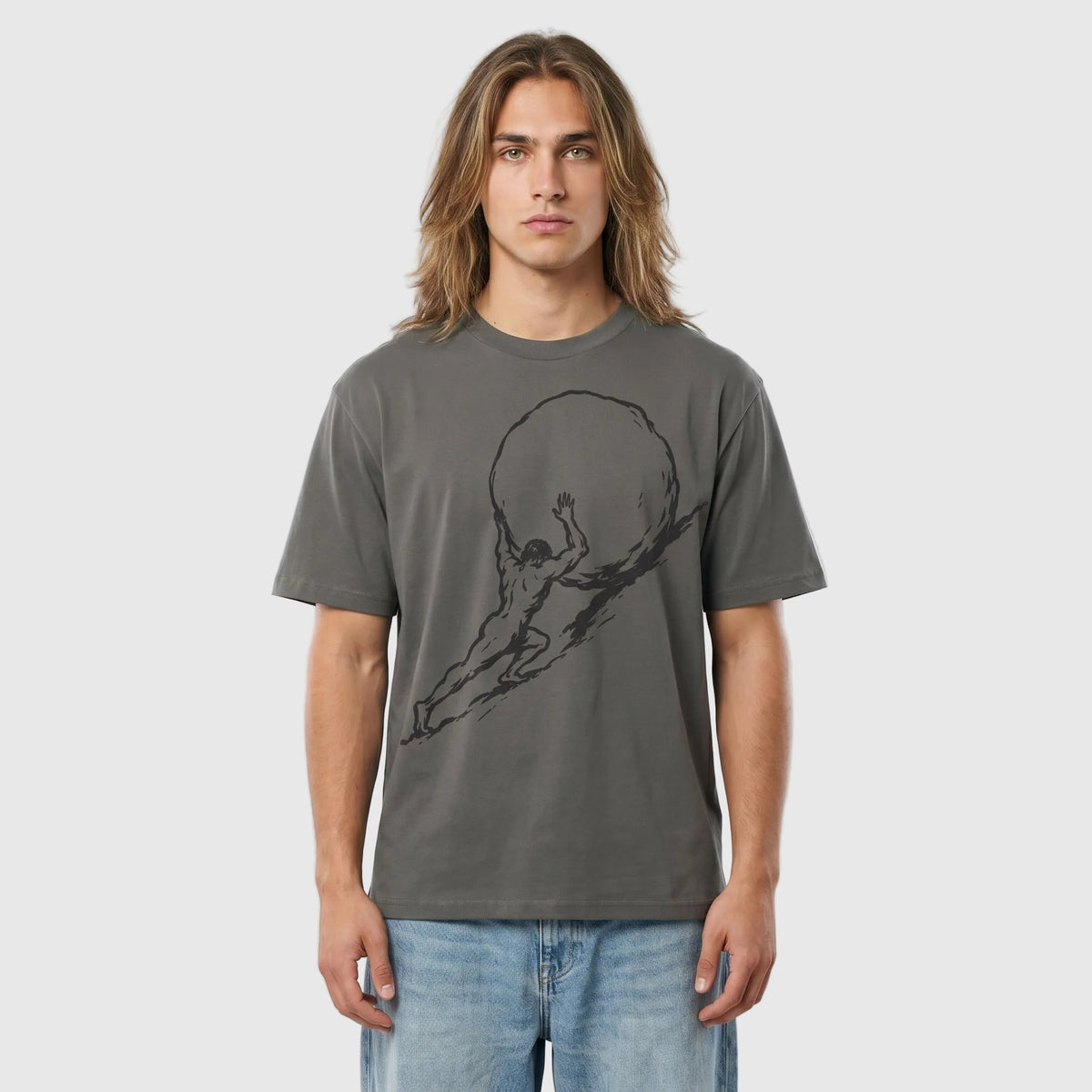 Man wearing a gray t-shirt with a graphic design against a plain background