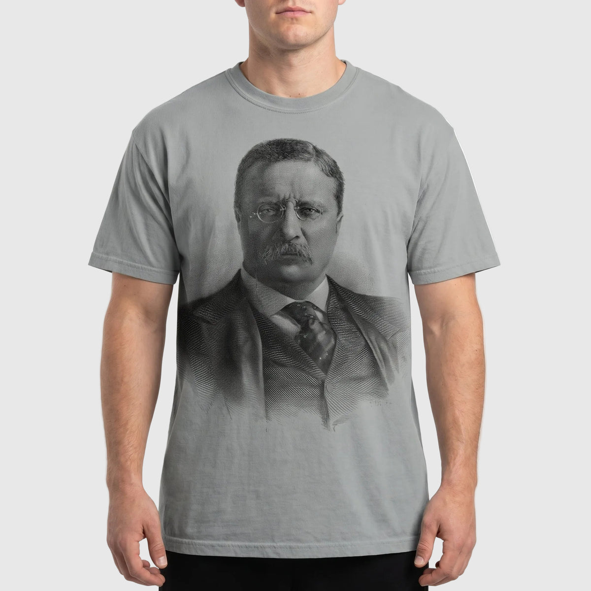 Person wearing a t-shirt with a printed design of a historical figure.