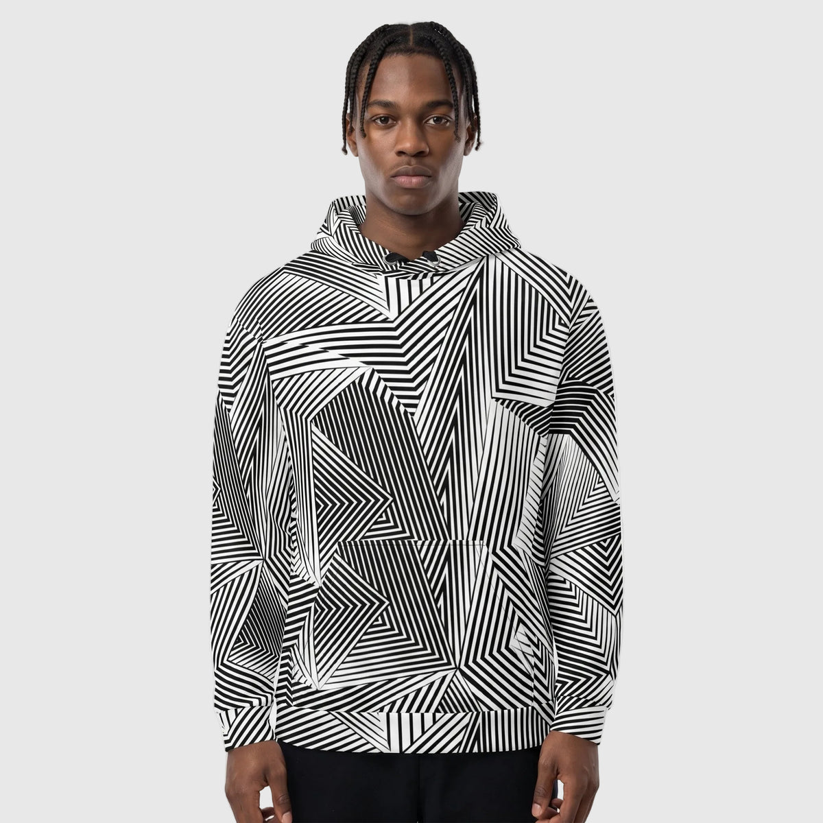 Person wearing a black and white geometric patterned hoodie against a plain background