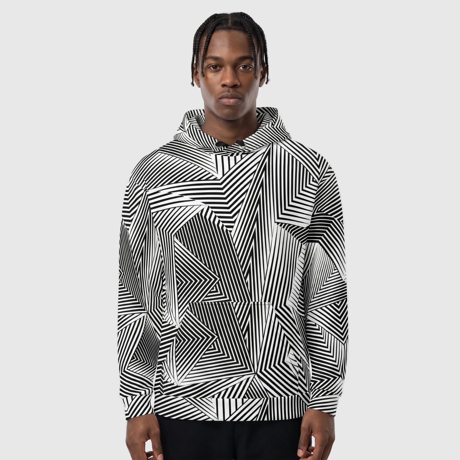 Person wearing a black and white geometric patterned hoodie against a plain background