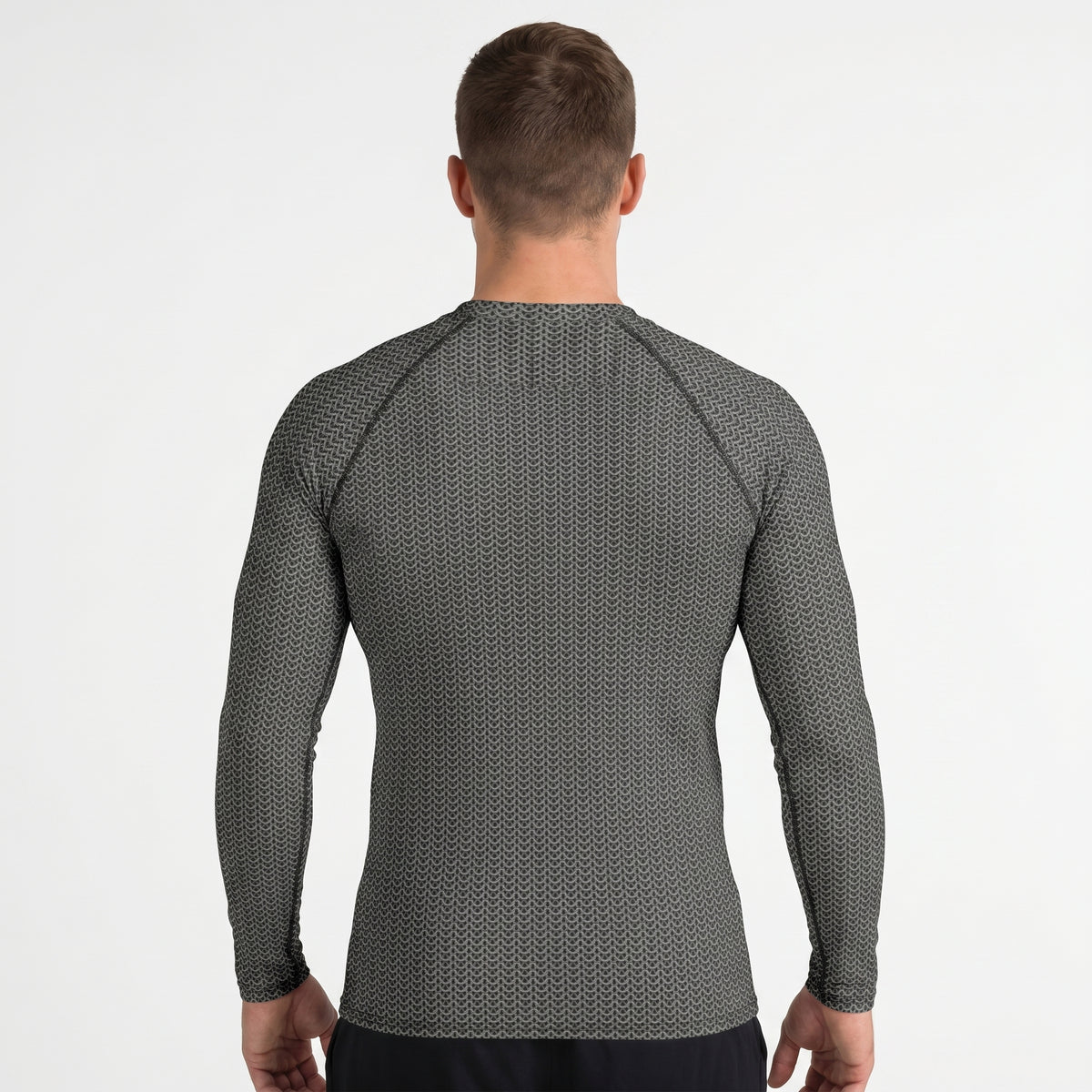 Man wearing a gray long-sleeve shirt with a subtle pattern on a white background