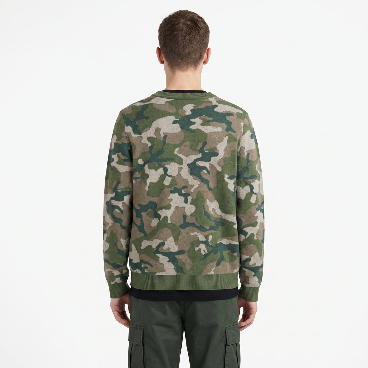 Person wearing a camouflage sweater on a white background
