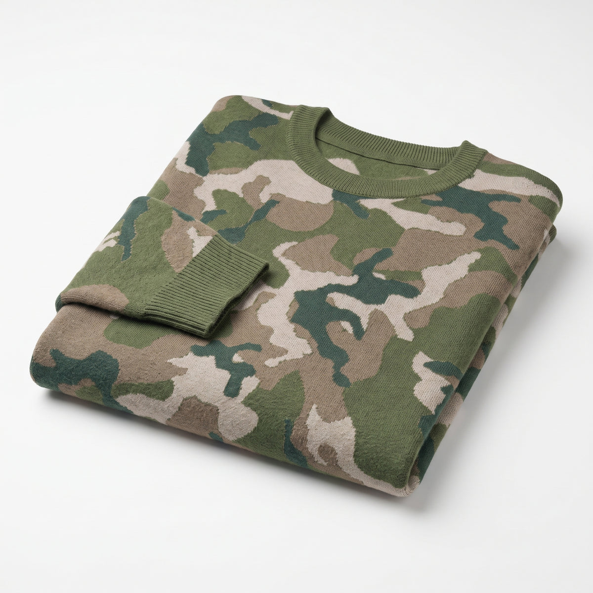 Folded camouflage sweater on a white background