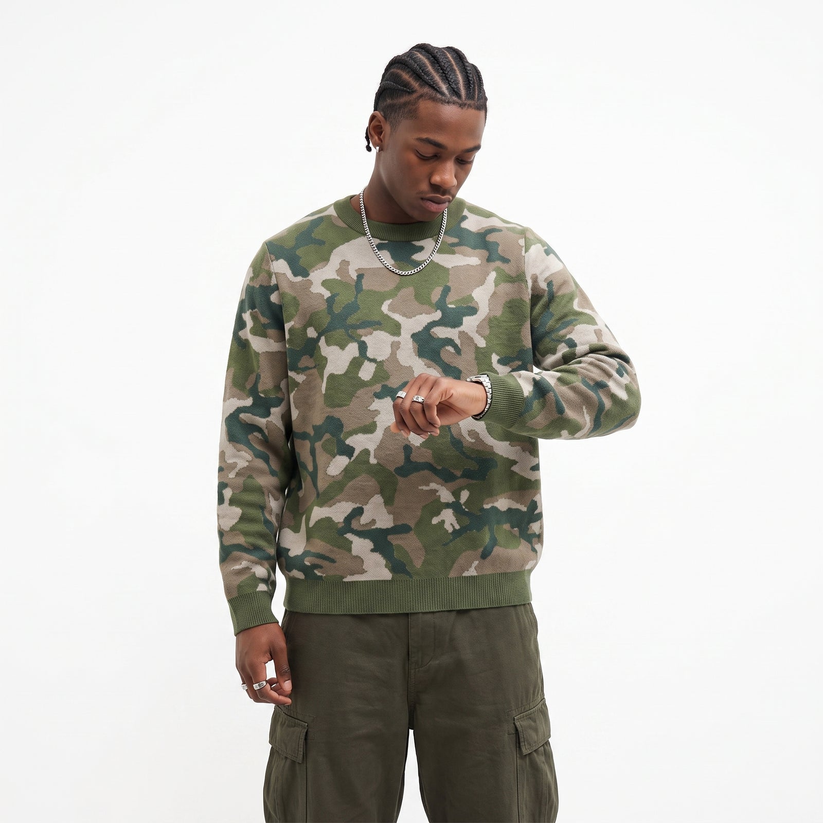 Person wearing a camouflage sweater and cargo pants on a white background