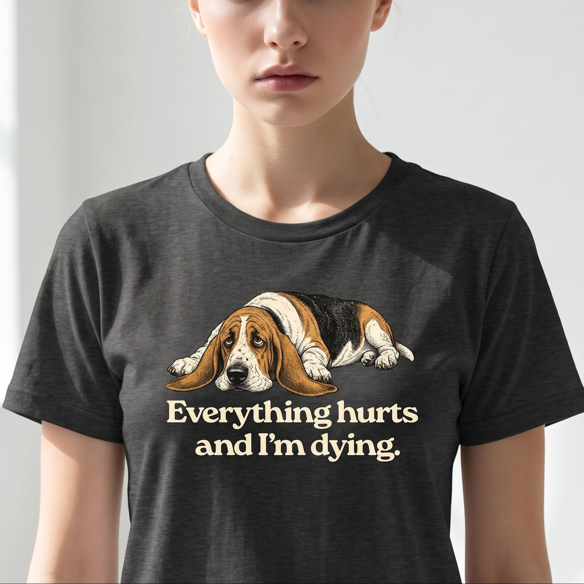 Person wearing a black t-shirt with a dog graphic and text on a plain background
