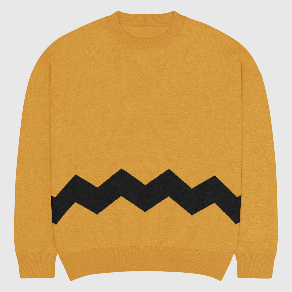 Yellow sweater with black zigzag pattern on a light gray background