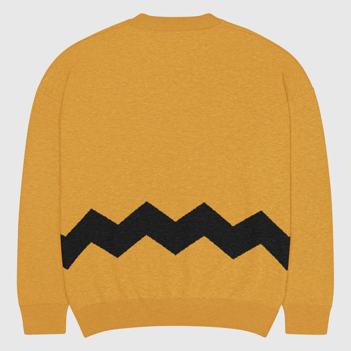 Yellow sweater with black zigzag pattern on a light gray background