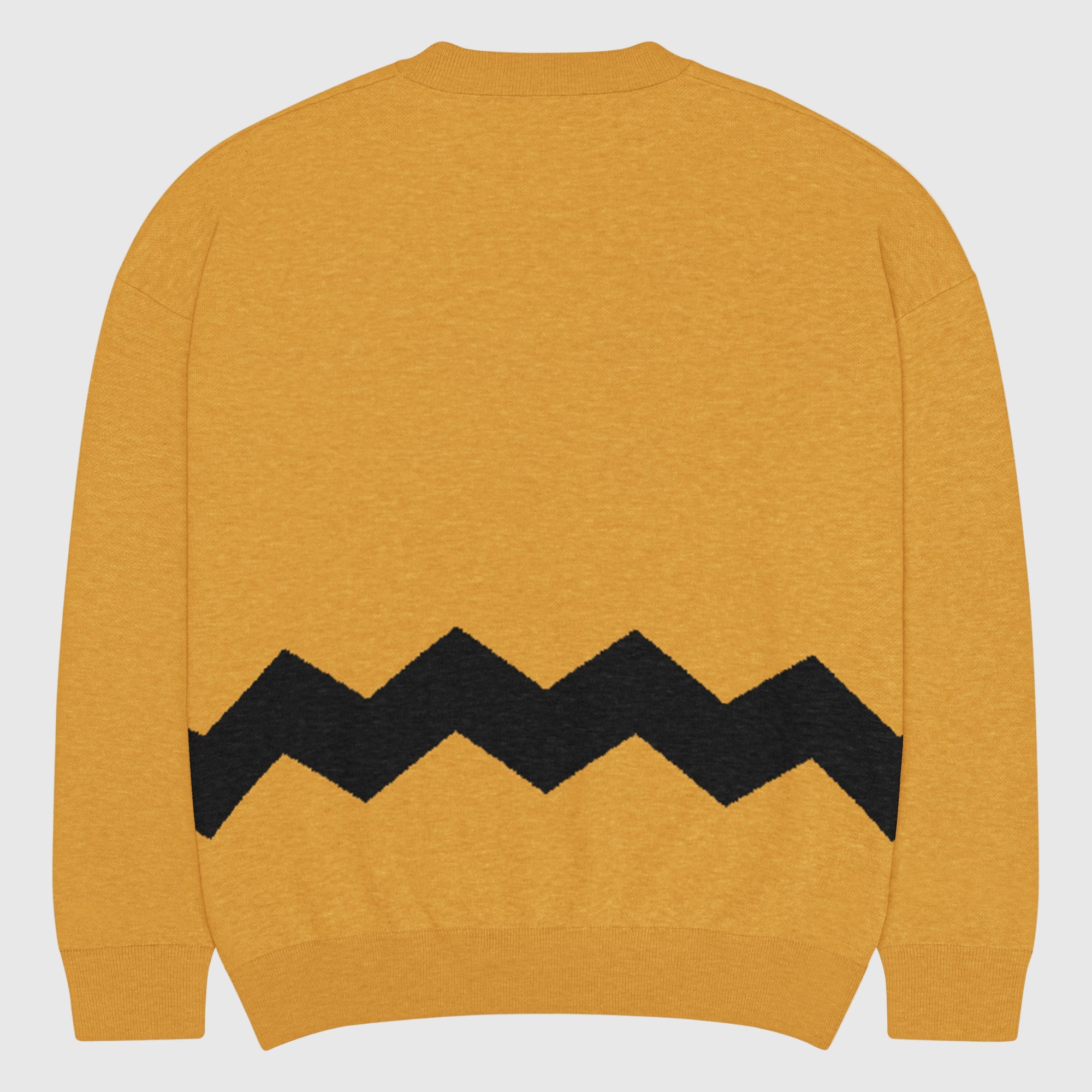 Yellow sweater with black zigzag pattern on a light gray background