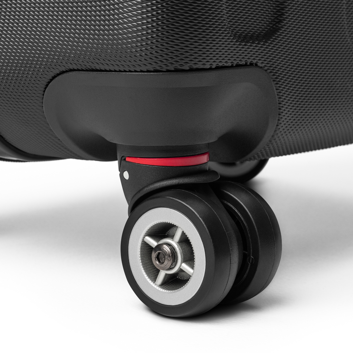 Close-up of a suitcase wheel on a light gray background
