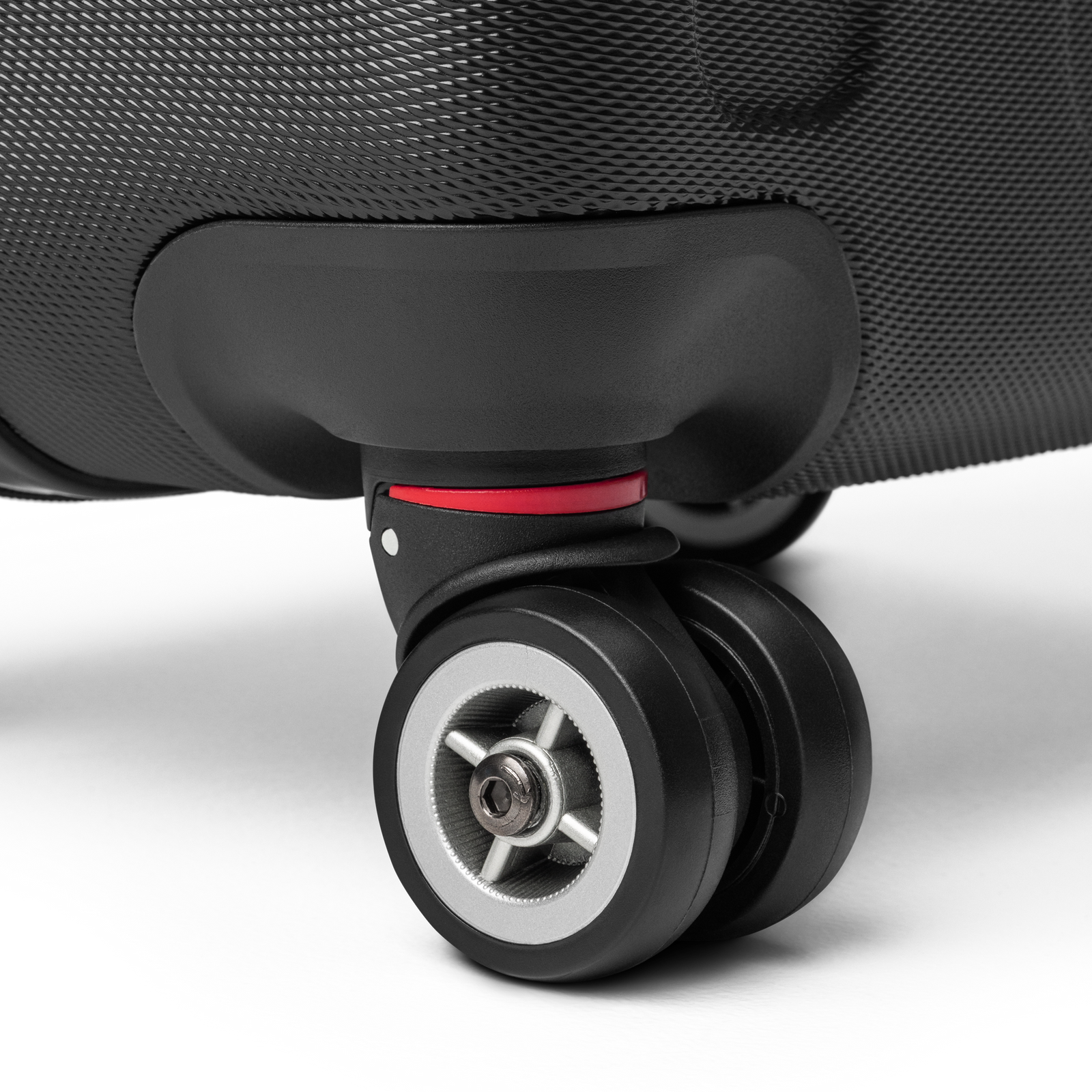 Close-up of a suitcase wheel on a light gray background