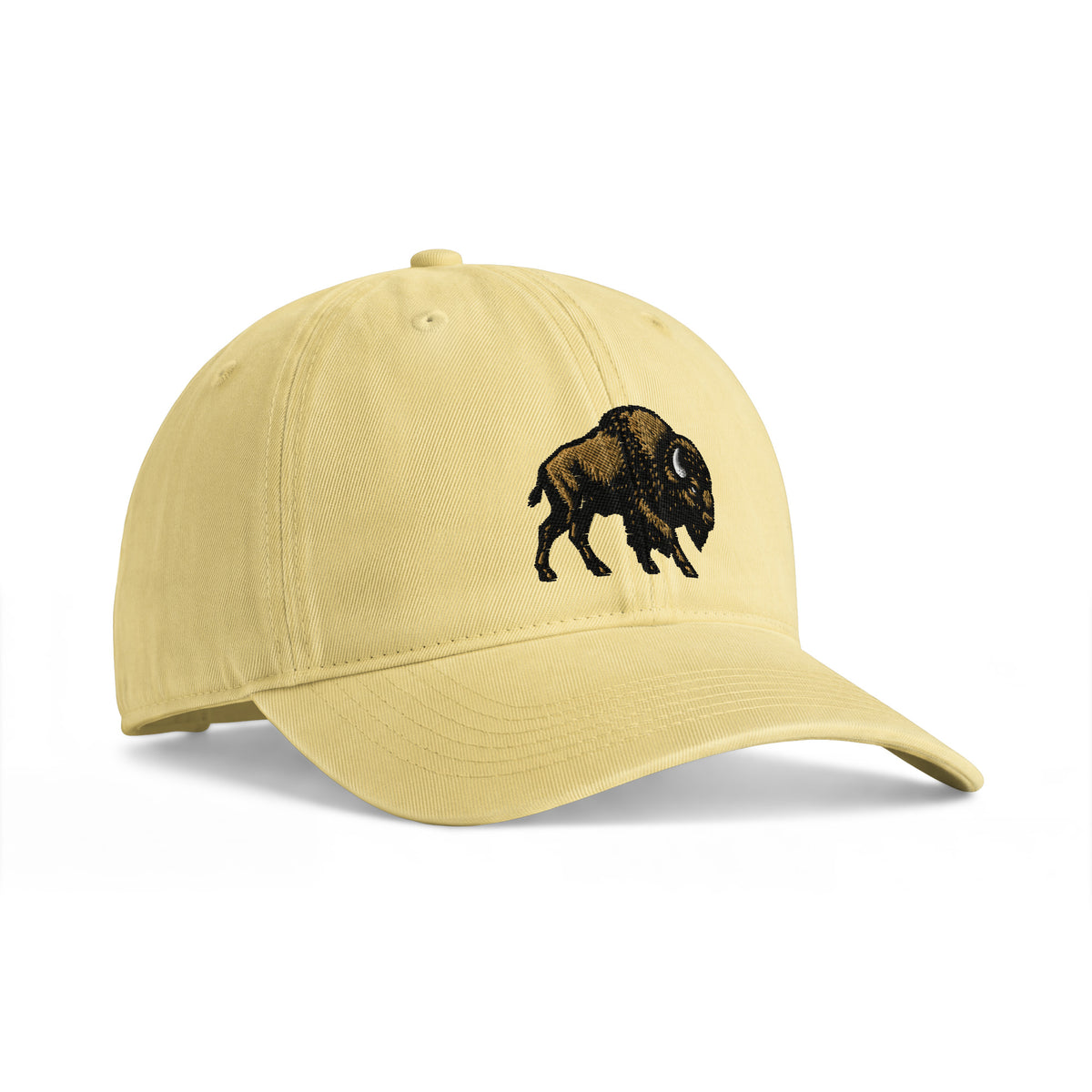 Bison sunwashed cotton cap in Butter, angled front view showing bison embroidery and the curved bill