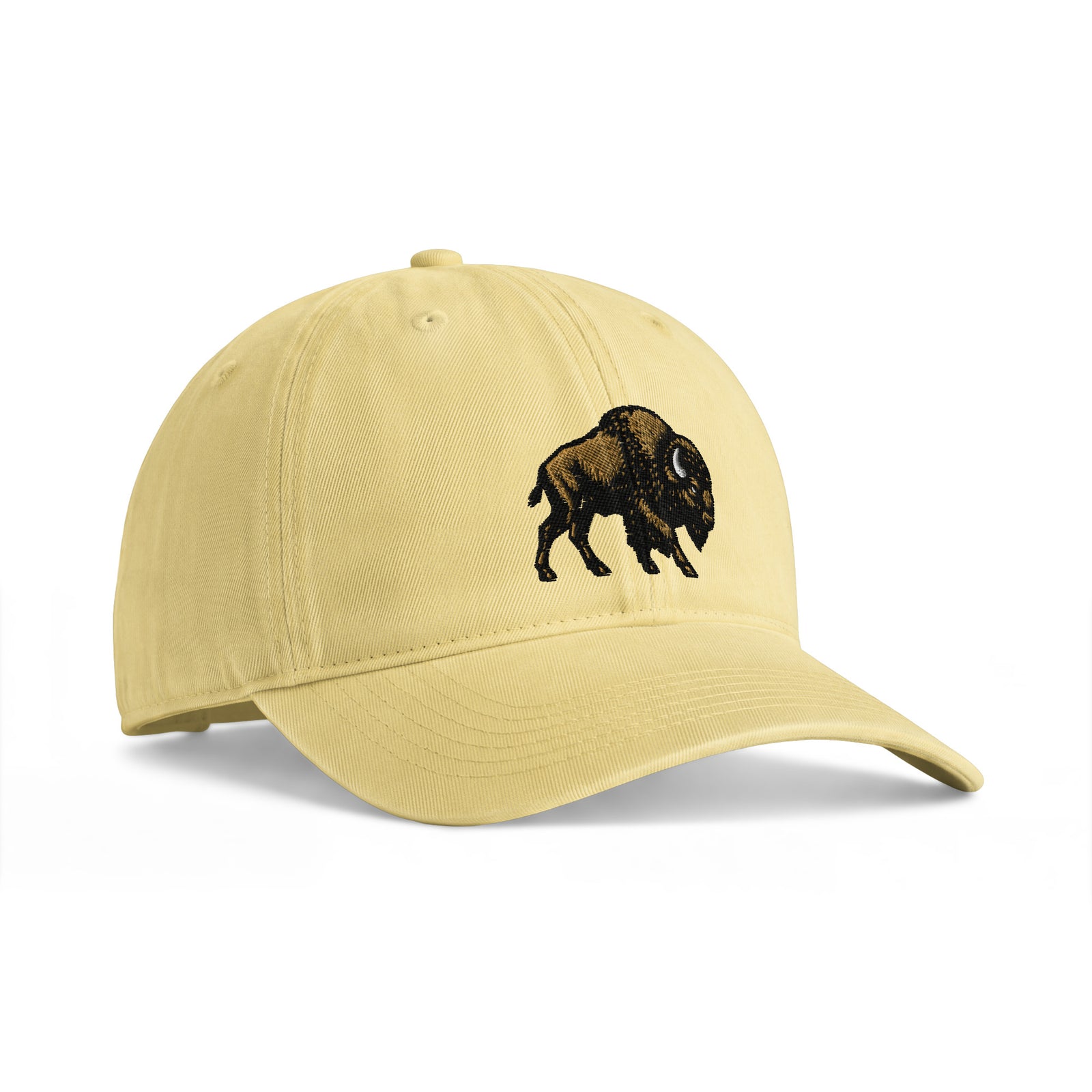Bison sunwashed cotton cap in Butter, angled front view showing bison embroidery and the curved bill