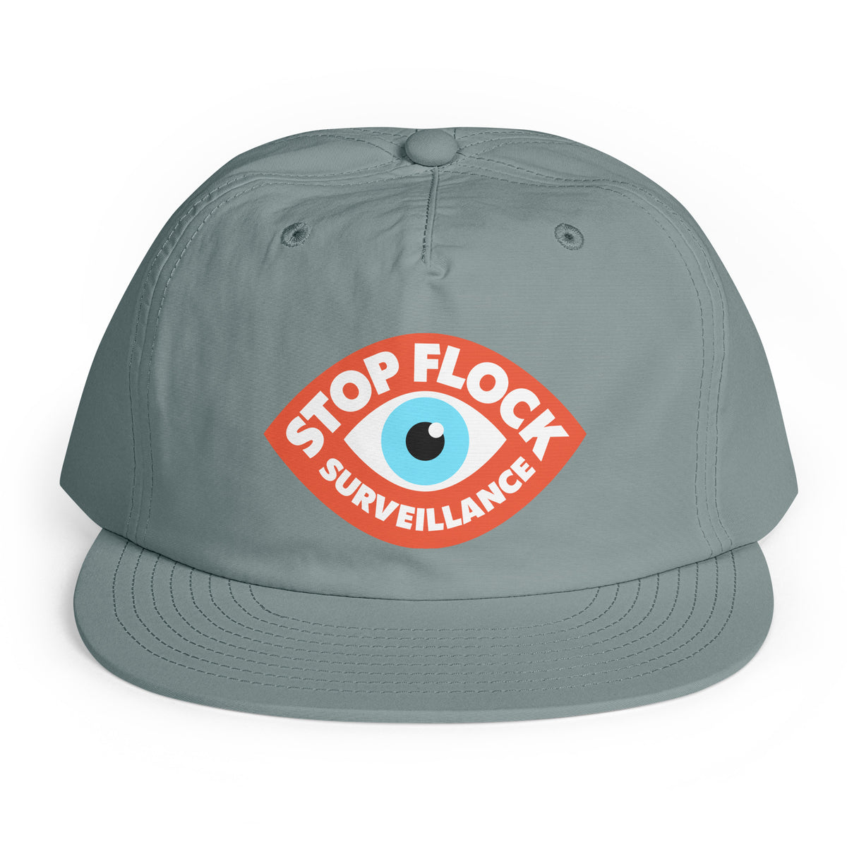 A gray snapback cap featuring a red, white, and blue graphic on the front with the text 'STOP FLOCK SURVEILLANCE' surrounding an eye illustration, set against a plain white background.