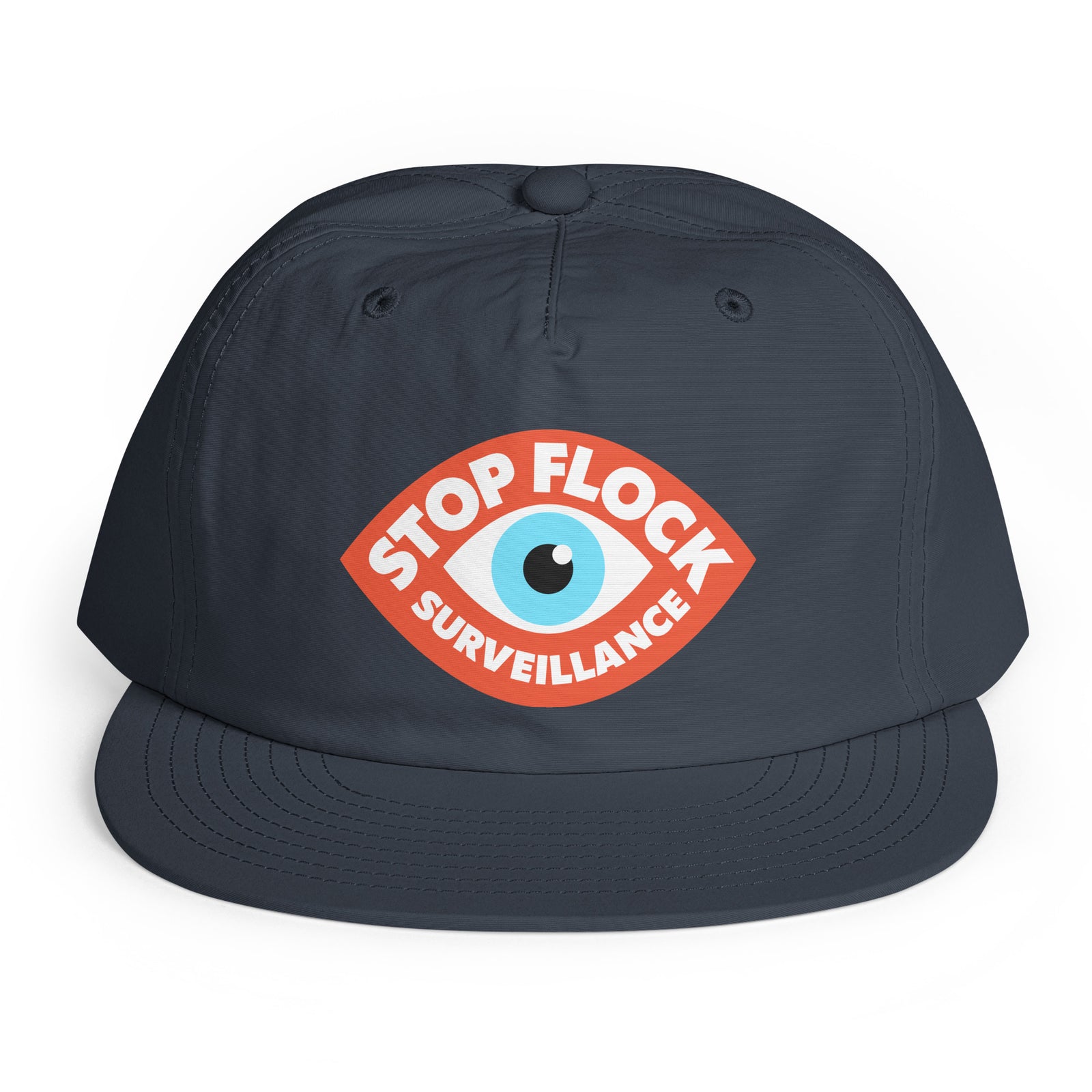 A dark navy blue flat-brim cap featuring a red, white, and light blue graphic on the front with the text 'STOP FLOCK SURVEILLANCE' surrounding an eye illustration.