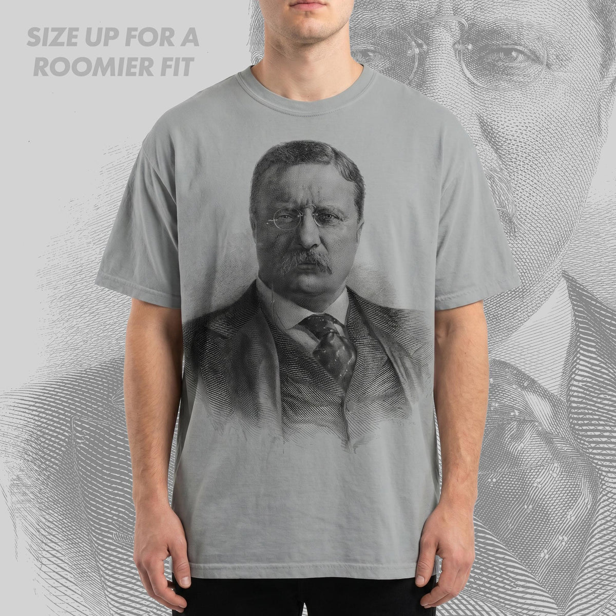 Person wearing a t-shirt with a printed design of a historical figure, with text 'SIZE UP FOR A ROOMIER FIT' above.