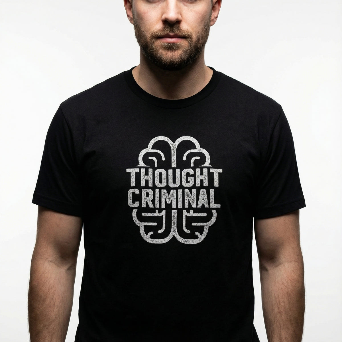 Man wearing a black t-shirt with &#39;Thought Criminal&#39; graphic design on a plain background