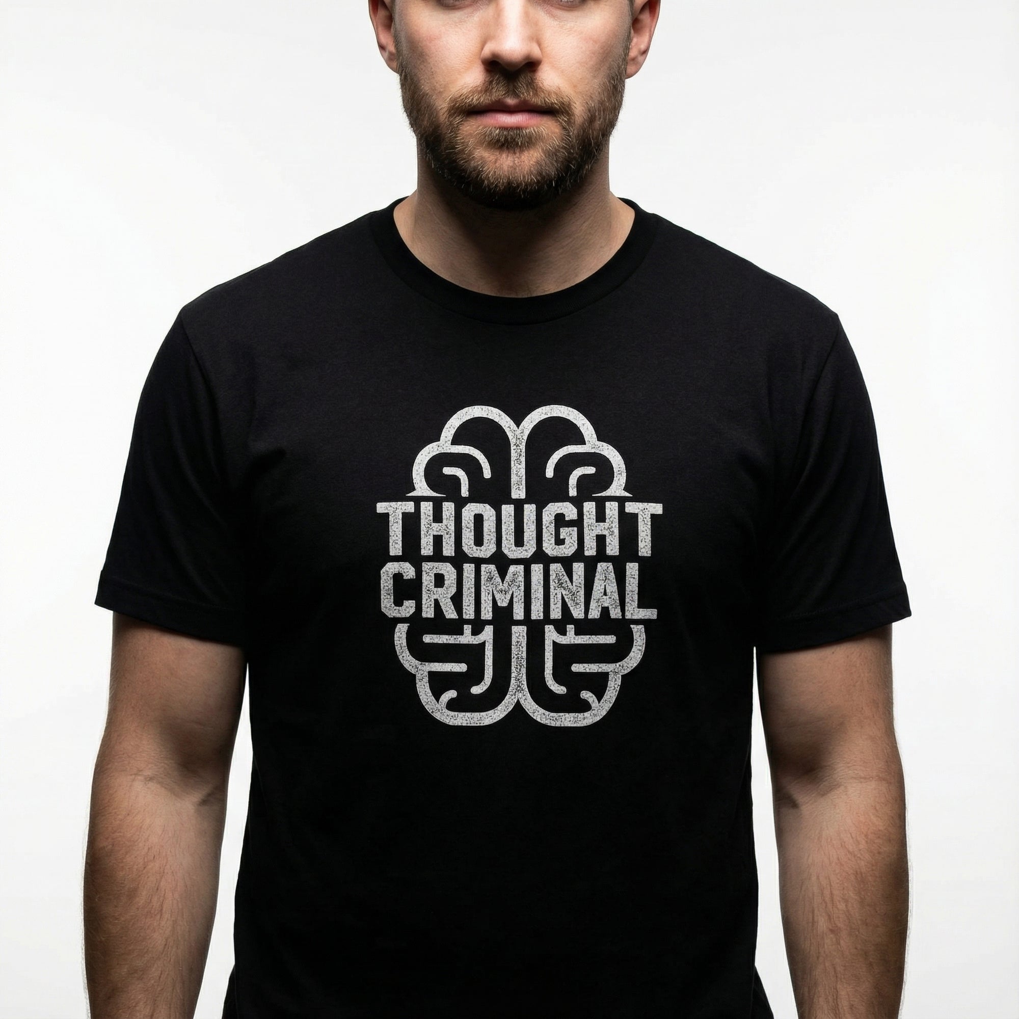 Man wearing a black t-shirt with 'Thought Criminal' graphic design on a plain background