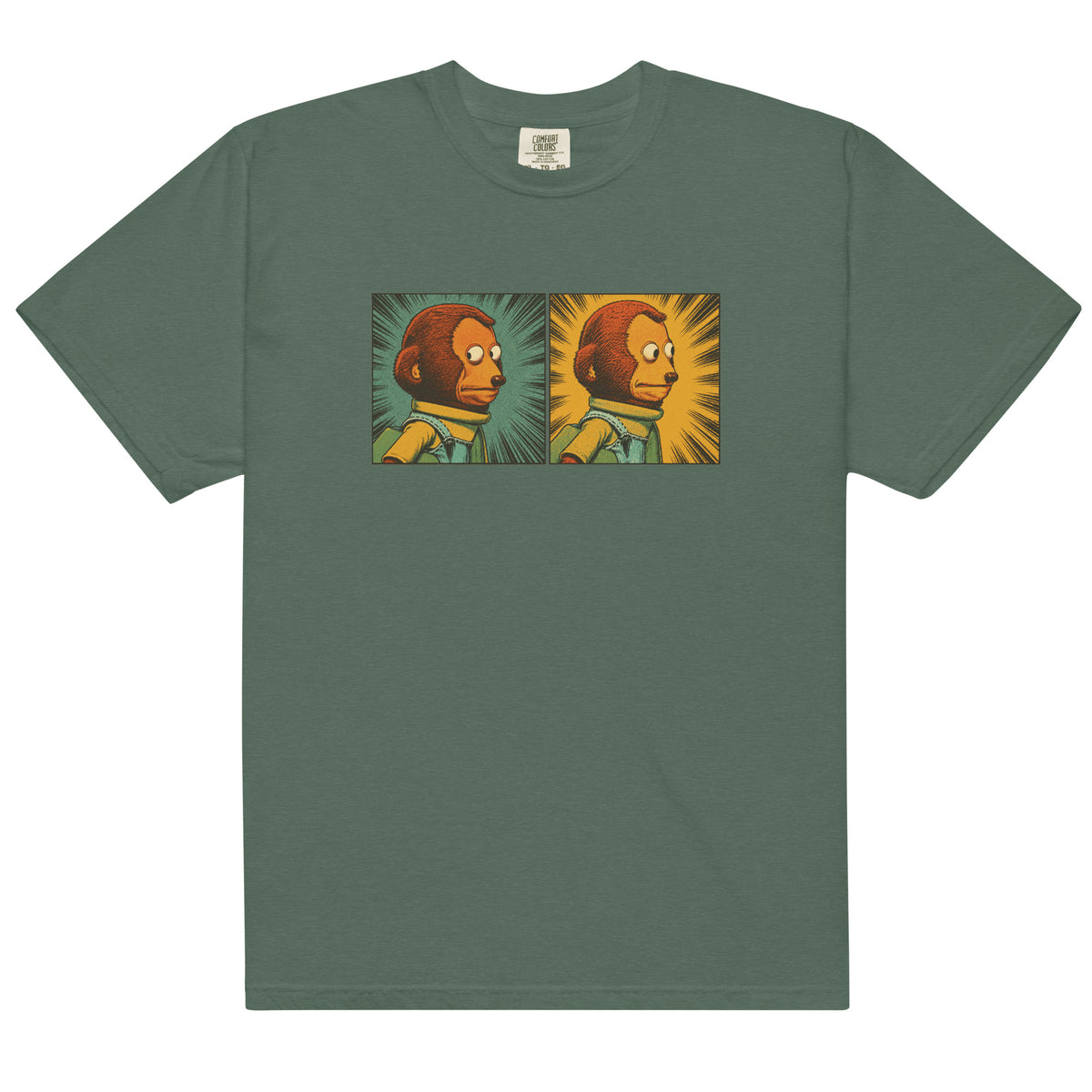 Flat lay sage green garment-dyed graphic T-shirt featuring a two-panel vintage comic-style monkey making an awkward side-eye expression.