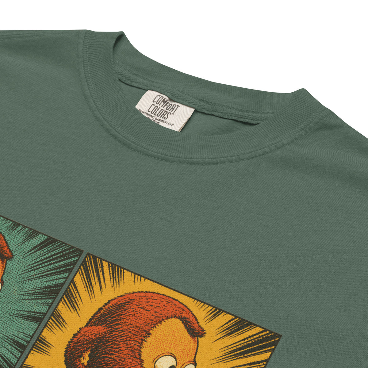 Close up of the collar of a Liberty Maniacs garment-dyed graphic T-shirt featuring a two-panel vintage comic-style monkey making an awkward side-eye expression.