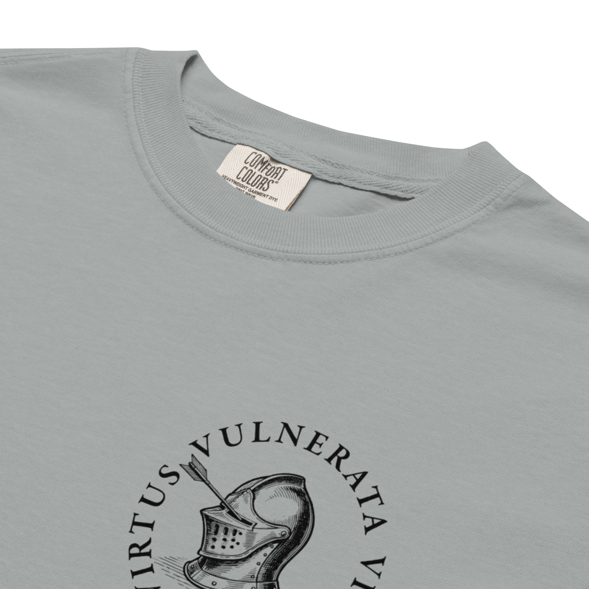 Minimalist graphic t-shirt featuring an illustrated medieval knight pierced by arrows with the Latin phrase Virtus Vulnerata Vincit (“Virtue, though wounded, conquers”).