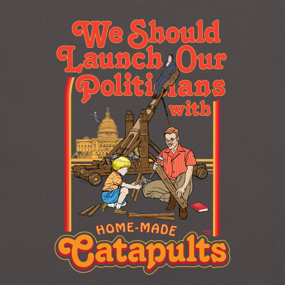 Gray t-shirt with a graphic design featuring text and images of people with a catapult, on a white background.