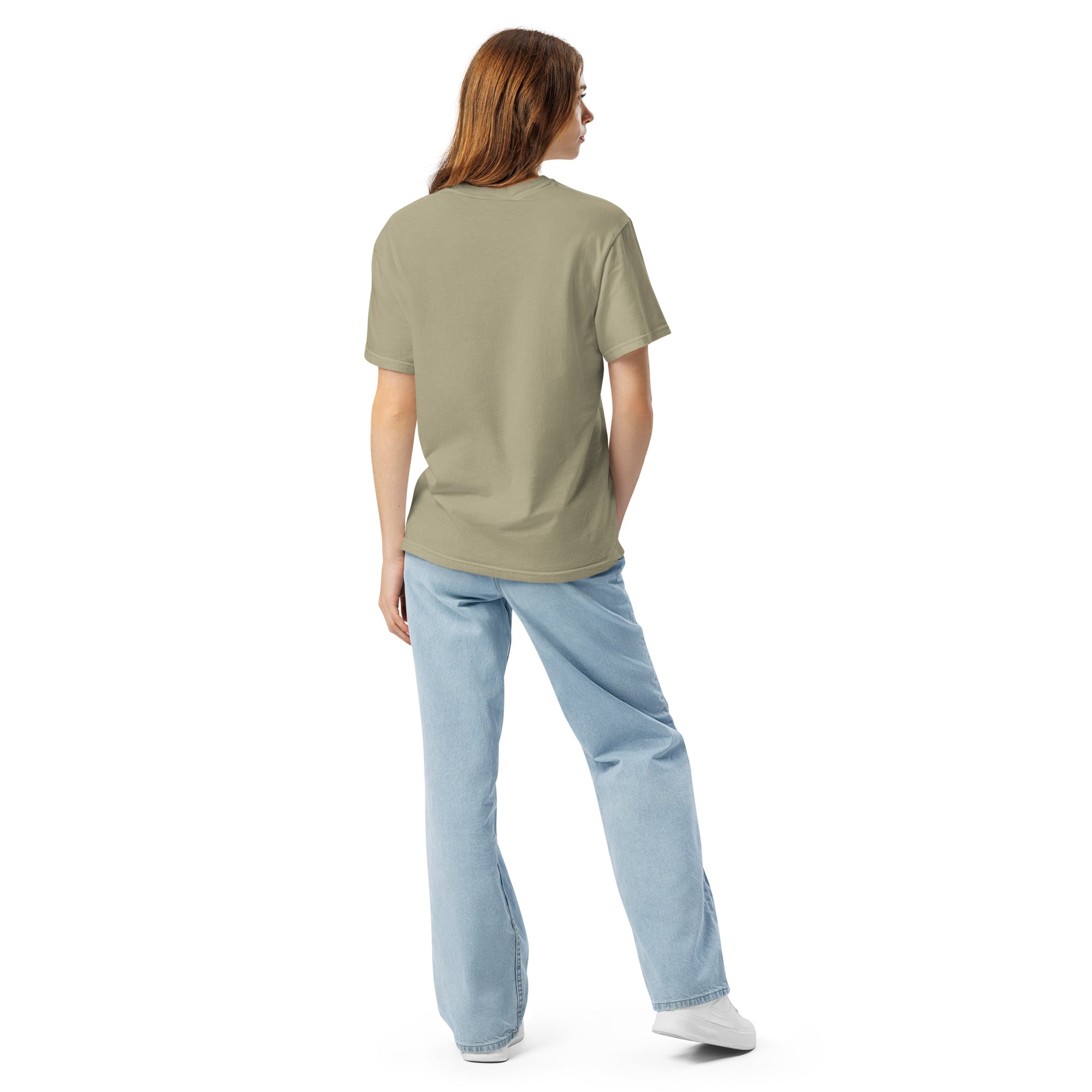 Person wearing a green t-shirt and light blue jeans on a white background