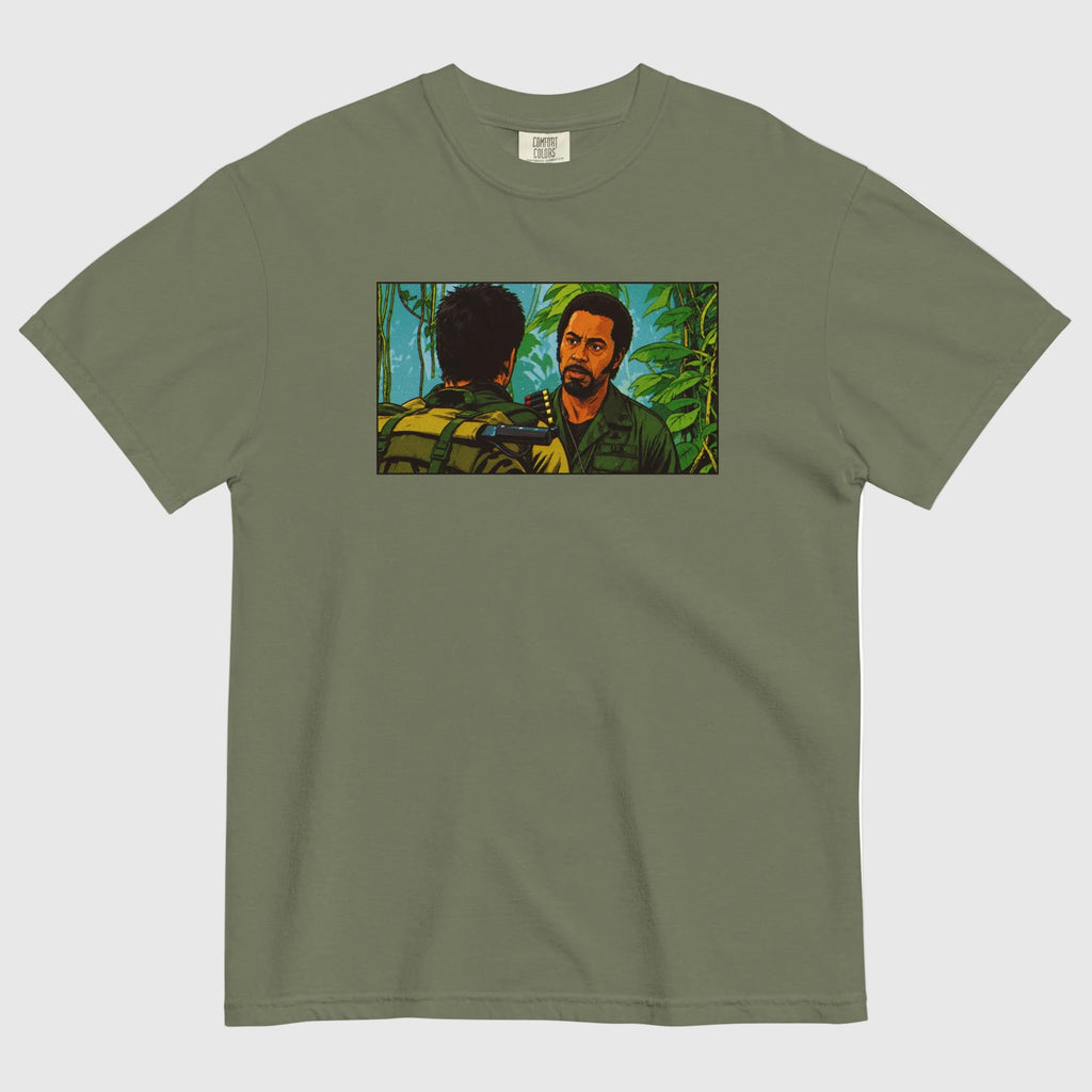Green t-shirt with a graphic of two men in a jungle setting on a white background