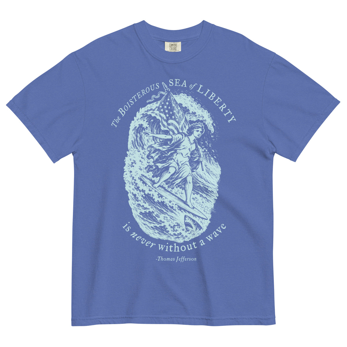 Sea of Liberty heavyweight T-shirt in Mystic Blue, front view with Lady Liberty surfing beside a shark