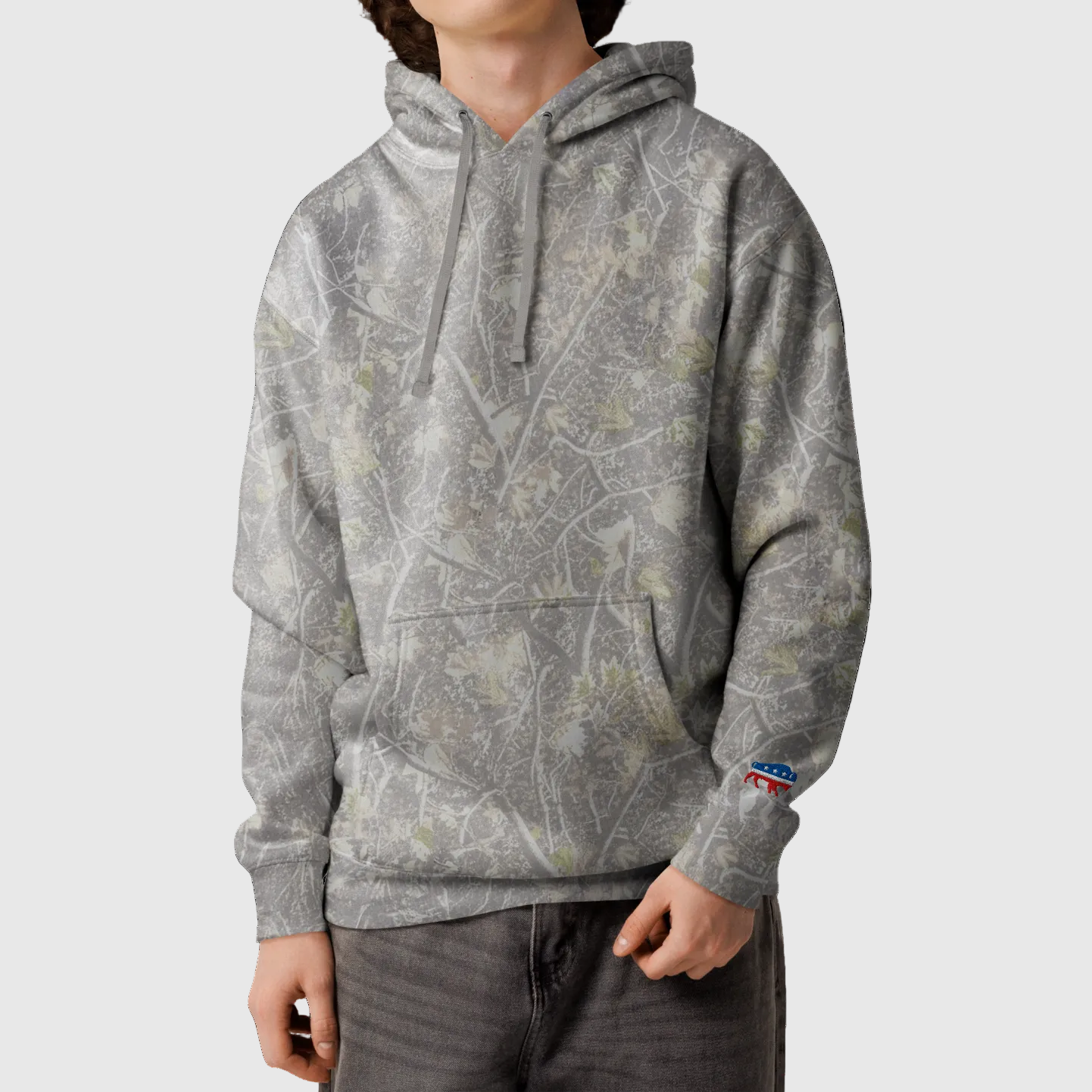 Person wearing a gray patterned hoodie on a white background