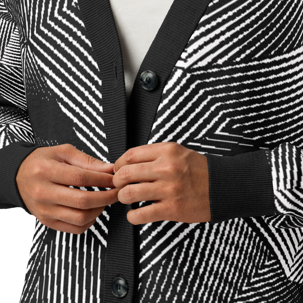 Close-up of a person wearing a black and white geometric patterned cardigan, with both hands buttoning the front.