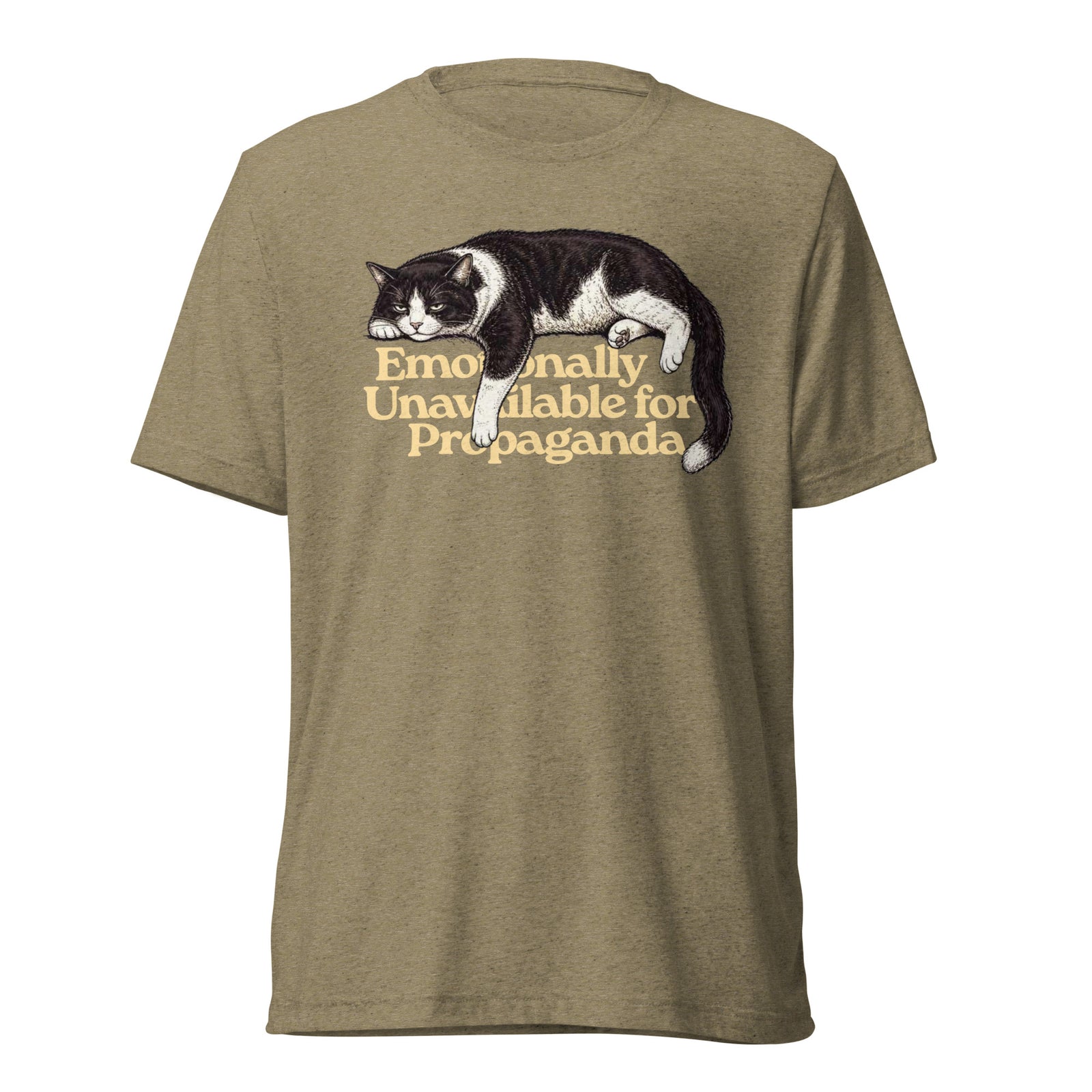 A heathered olive green short-sleeve t-shirt featuring a graphic of a black and white cat lying down with the text 'Emotionally Unavailable for Propaganda' printed in a warm tan font.