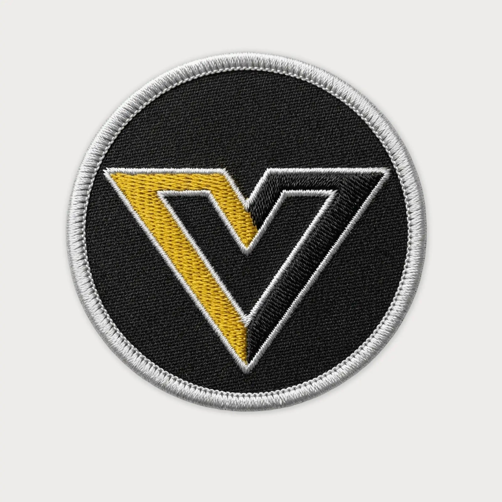 Patch with a voluntaryist logo on a black background, framed by a silver border.