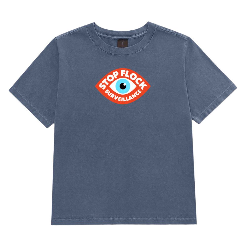 A faded blue short-sleeve t-shirt with a circular graphic on the chest featuring an eye and the text 'STOP FLOCK SURVEILLANCE' in white and orange.