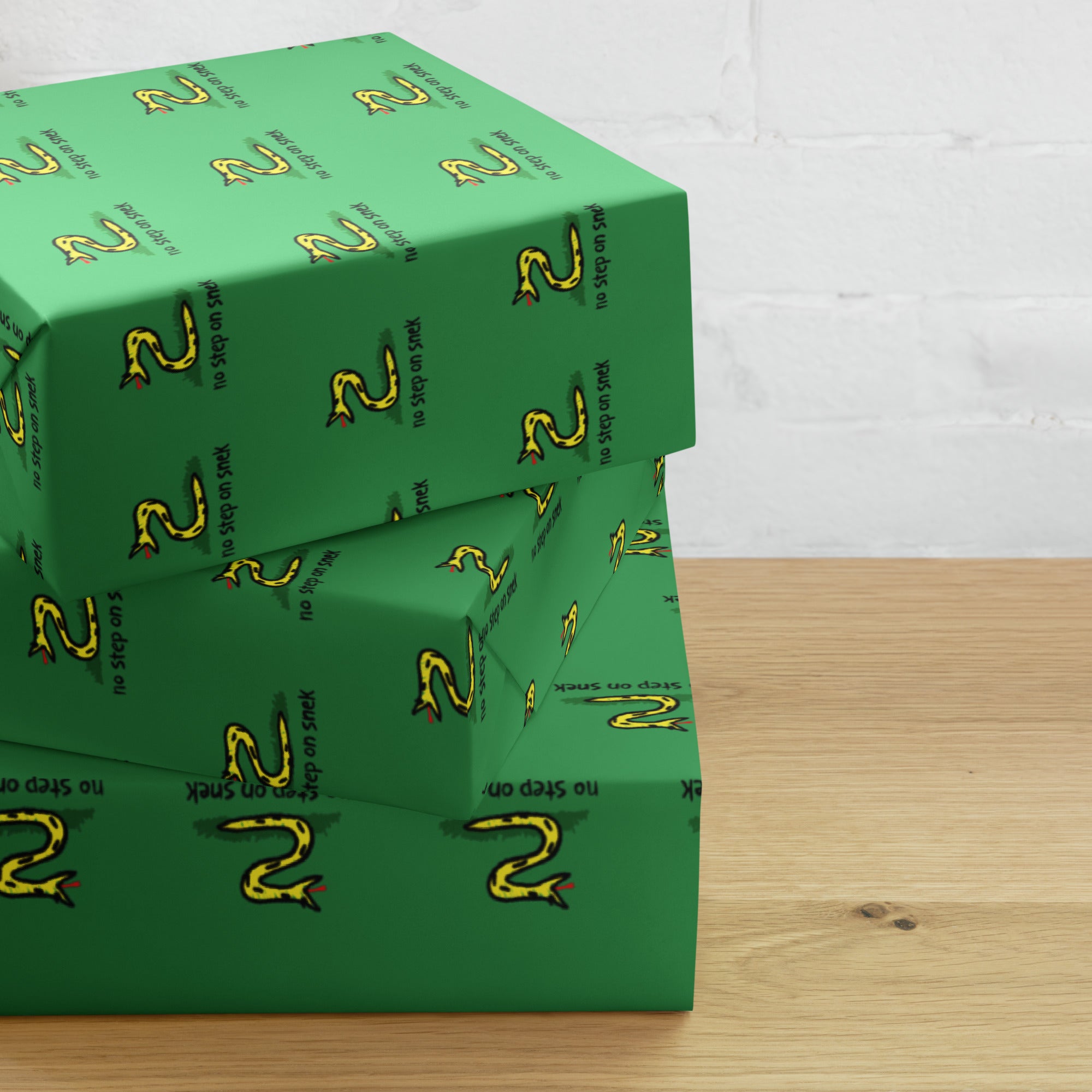 Green boxes with a snake pattern on a wooden surface
