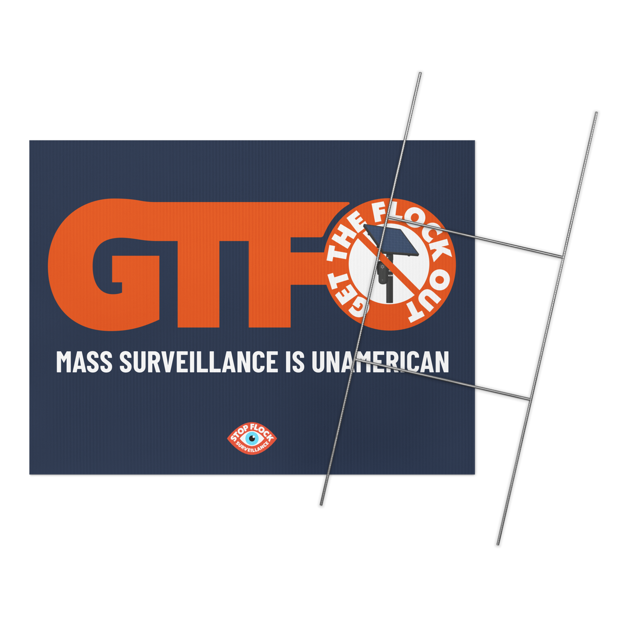 A rectangular protest-style sign with a dark navy background, large orange 'GTF' lettering, white text reading 'MASS SURVEILLANCE IS UNAMERICAN,' and an orange circular graphic with a red slash over a black-and-white police scanner icon. A small eye logo appears near the bottom.