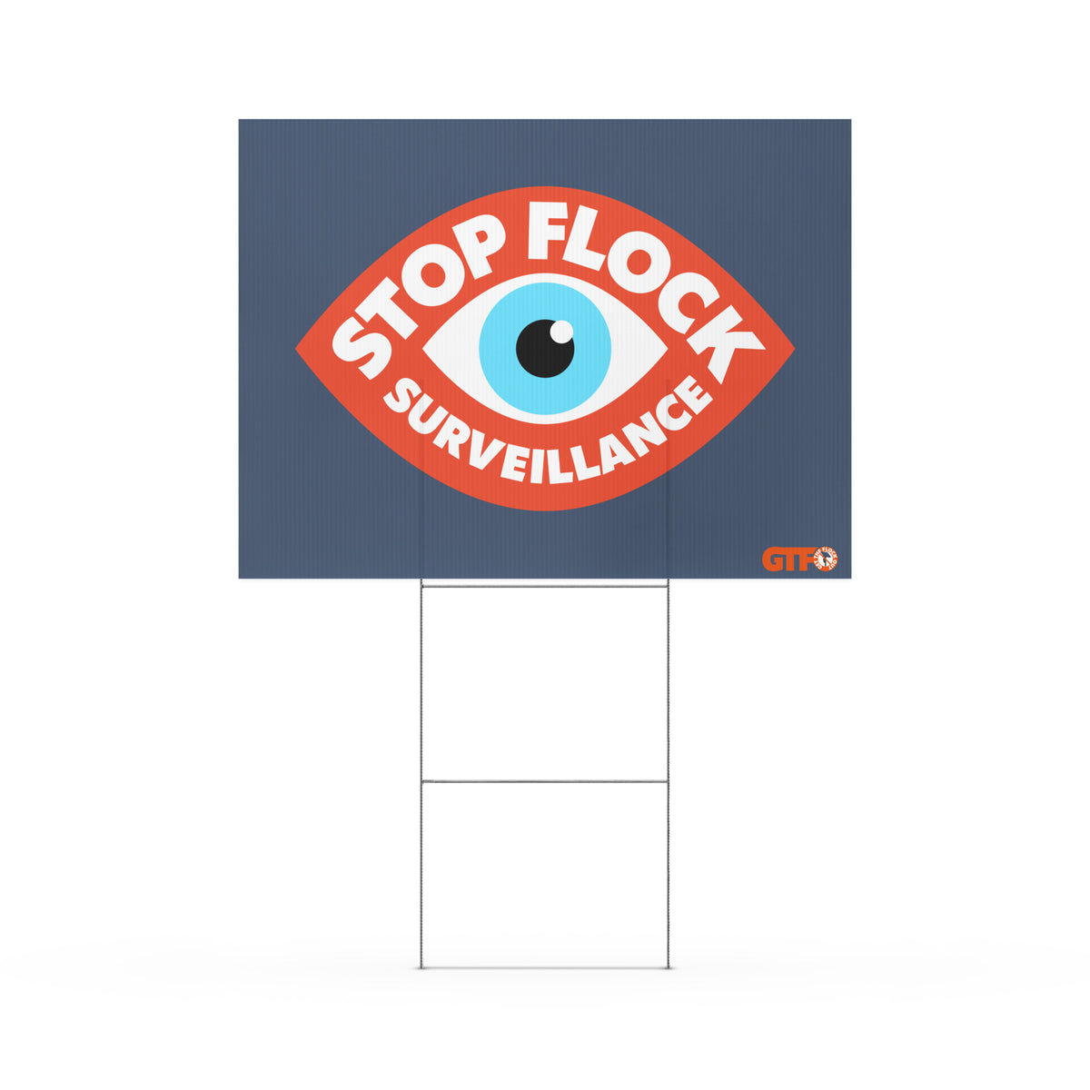 A rectangular yard sign with a dark blue background featuring a large red eye graphic and the words “STOP FLOCK SURVEILLANCE” in white. The sign is mounted on a metal H-stake and shown against a plain white background.