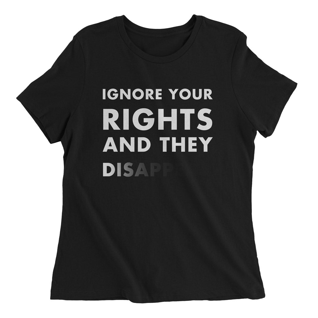Woman wearing a black t-shirt with white text that says Ignore Your Rights and they Disappear.