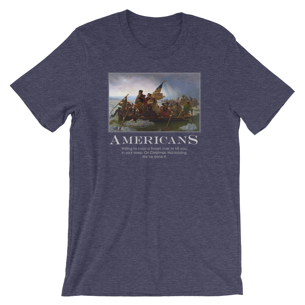 a heather navy-blue t-shirt from Liberty Maniacs. The t-shirt features a large graphic of the historical painting "Washington Crossing the Delaware." Below the painting, the word "AMERICANS" is written in a large, bold font. Underneath, smaller text reads: "Willing to cross a frozen river to kill you in your sleep. On Christmas. Not kidding. We've done it."