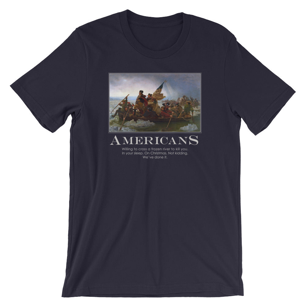 a navy-blue t-shirt from Liberty Maniacs. The t-shirt features a large graphic of the historical painting "Washington Crossing the Delaware." Below the painting, the word "AMERICANS" is written in a large, bold font. Underneath, smaller text reads: "Willing to cross a frozen river to kill you in your sleep. On Christmas. Not kidding. We've done it."