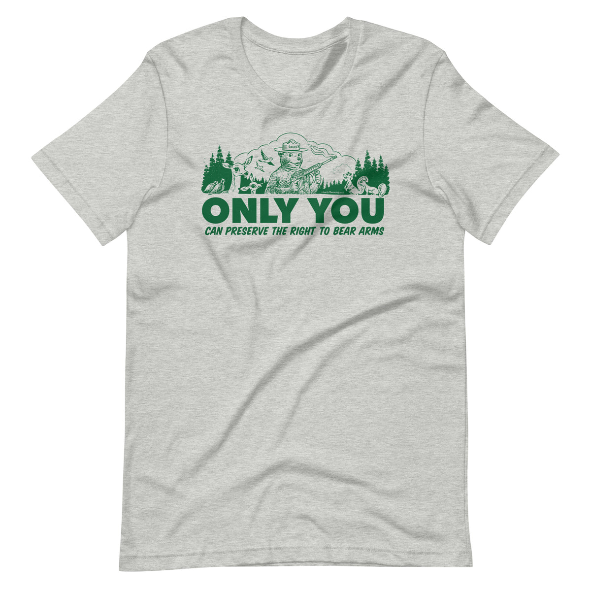 
A heather gray t-shirt with a green graphic. The graphic shows a cartoon bear resembling Smokey Bear, wearing a ranger hat and holding a hunting rifle. The bear is centered in a forest setting with a deer, squirrels, and birds nearby. Below the image, large text reads, &quot;ONLY YOU CAN PRESERVE THE RIGHT TO BEAR ARMS.&quot;