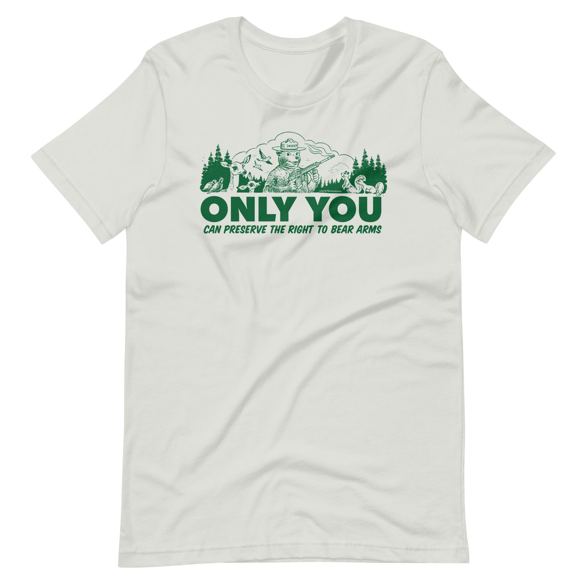 
A gray t-shirt with a green graphic. The graphic shows a cartoon bear resembling Smokey Bear, wearing a ranger hat and holding a hunting rifle. The bear is centered in a forest setting with a deer, squirrels, and birds nearby. Below the image, large text reads, &quot;ONLY YOU CAN PRESERVE THE RIGHT TO BEAR ARMS.&quot;