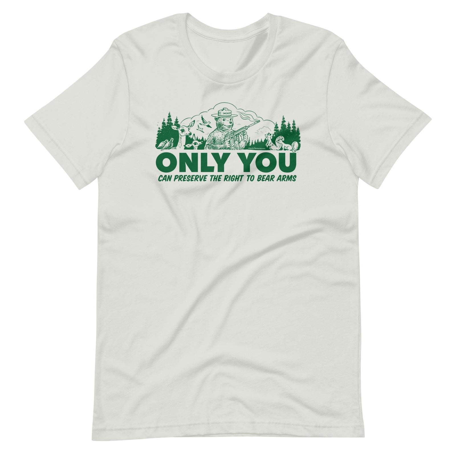 
A gray t-shirt with a green graphic. The graphic shows a cartoon bear resembling Smokey Bear, wearing a ranger hat and holding a hunting rifle. The bear is centered in a forest setting with a deer, squirrels, and birds nearby. Below the image, large text reads, "ONLY YOU CAN PRESERVE THE RIGHT TO BEAR ARMS."