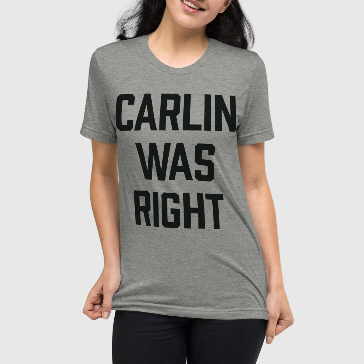 Person wearing a gray t-shirt with &#39;CARLIN WAS RIGHT&#39; text on a white background